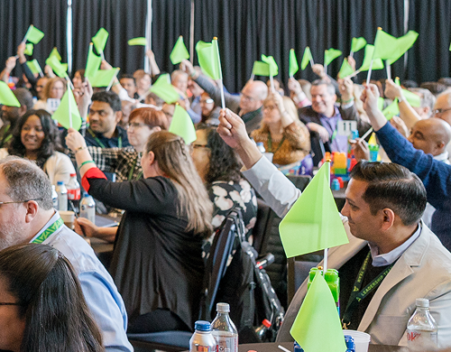 Acentra Health Employees Waving Flags Celebrating Growth